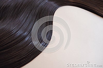 texture of beautiful glossy long hair.Curl female healthy hair. Concept hairdresser spa salon. strand of brunette silky Stock Photo