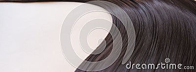 texture of beautiful glossy long hair.Curl female healthy hair. Concept hairdresser spa salon. strand of brunette silky Stock Photo