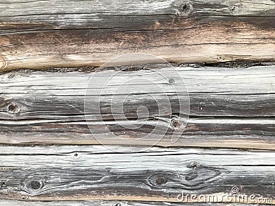 Texture of a black gray old wood wall made of logs, a fence of horizontal worn-out burnt, rotten boards with cracks and knots Stock Photo