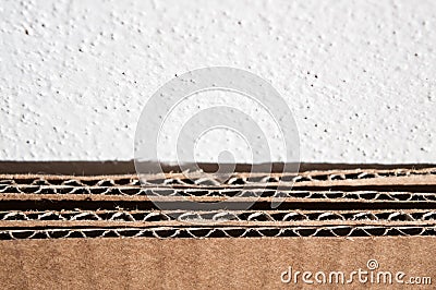 Texture of brown cardboard side. Folded cardboard boxes against Stock Photo