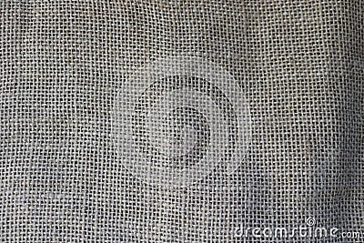 Texture of brown old canvas, linen natural material with a coarse perpendicular interlacing of the fibers of the fabric. Stock Photo