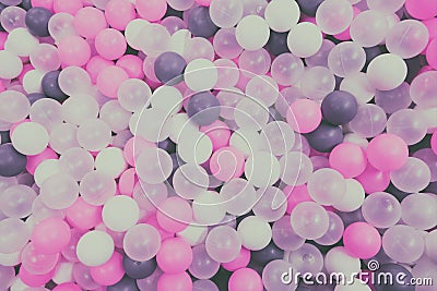Texture of colored balls of the same size, background muted soft tones. Top view Stock Photo