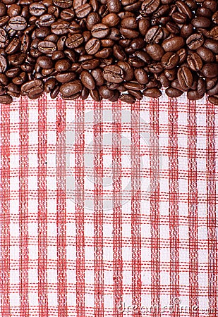 Texture of a colored towel, a towel of a cellular type, on which lies a certain amount of brown coffee beans. Top view with a bunc Stock Photo
