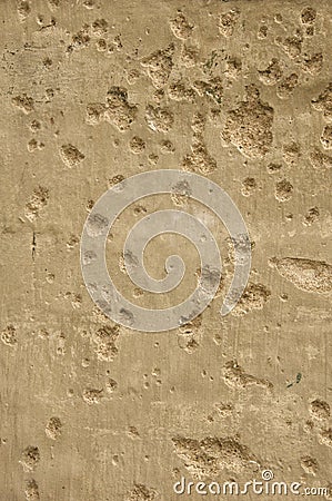 Texture of a concrete wall spotted with bullet holes. Stock Photo