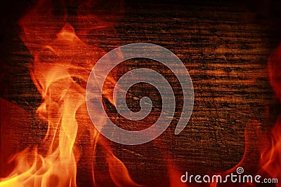 Texture of dark wood and frame out of the fire. Wood brown texture around the burning bright flame. Background of old panels. Stock Photo