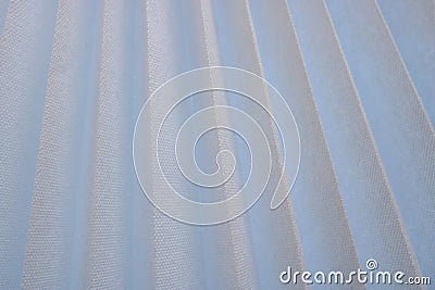 Texture of diagonal stripes with a shadow, with triangular curved ribs, edges of light white fabric, paper with triangular strips Stock Photo