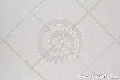 The texture of a false ceiling consisting of square plates and a directing profile of the diagonal arrangement Stock Photo
