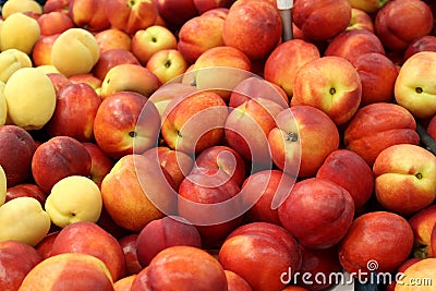 Texture of juicy bright nectarine in one heap. Stock Photo
