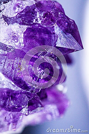 Texture of gemstone lilac Amethyst closeup as a part of cluster geode filled with rock Quartz crystals. Stock Photo