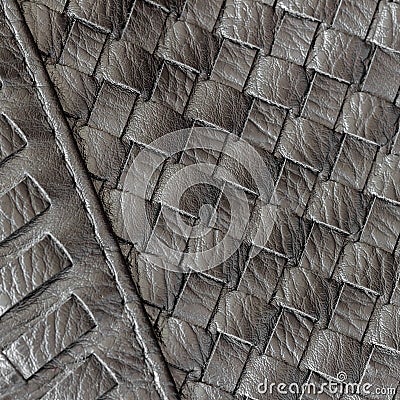 Texture of genuine dark wicker leather close-up and details with stitches of male handbag. Concept of shopping Stock Photo