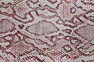 Texture of genuine leather close-up, embossed under the skin a reptile, with fashion pattern and matte surface. Claret Stock Photo