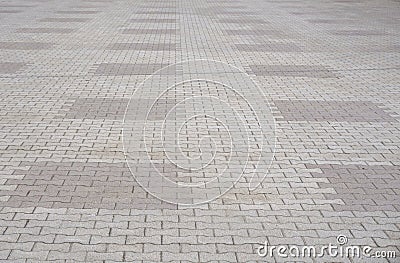 Texture of gray and yellow patterned paving tiles on the ground of street, perspective view. Cement brick squared stone floor back Stock Photo