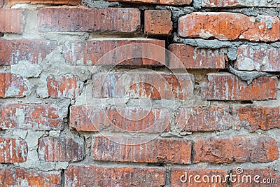 Texture of an old broken red brick wall with cement mortar. Background of clay and silicate brick on broken wall with large cracks Stock Photo