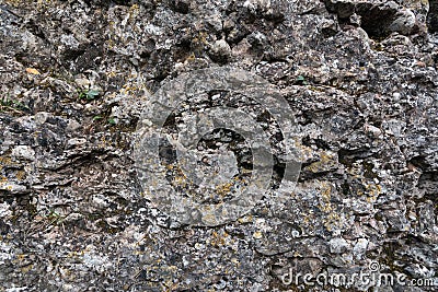 Texture of old mossy weathered rocks with cracks Stock Photo