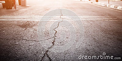 Texture of the old road with cracks. Asphalt surface on the street. Glare of light. Web banner size. 16 in 9 crop Stock Photo