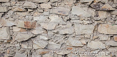 Texture of an old stone wall closeup as background. Antique flat stone natural wall Stock Photo
