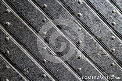 Texture of old wooden plank door with iron rivets Stock Photo