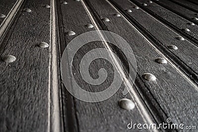 Texture of old wooden plank door with iron rivets Stock Photo