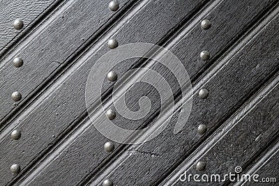 Texture of old wooden plank door with iron rivets Stock Photo