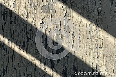 Texture of old wooden wall with cracking white paint with dark diagonal shadows Stock Photo