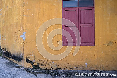 Texture of old yellow vintage wall of industrial factory with wood window Stock Photo