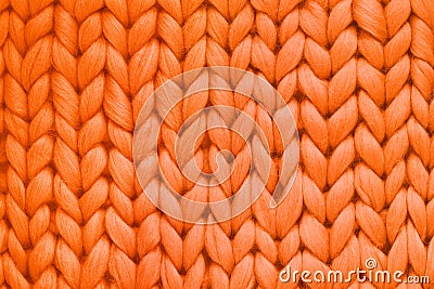 Texture of orange wool big knit blanket. Large knitting. Plaid merino wool. Top view Stock Photo