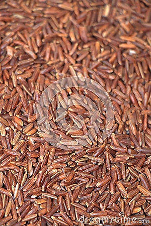 Raw long grains of red rice texture Stock Photo