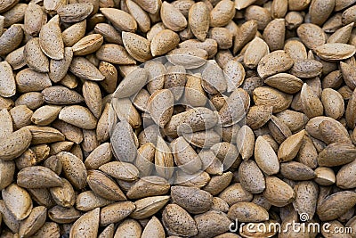 Texture of raw unshelled almonds, top view. Almond nuts background Stock Photo
