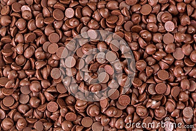 Texture of small chunks of sweetened chocolate chips background Stock Photo