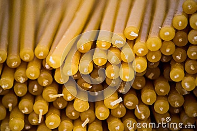 Texture of a stack of yellow church candles Stock Photo