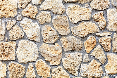 Texture of a stone wall extruded from a large cobblestone of a shell rock, closeup Stock Photo