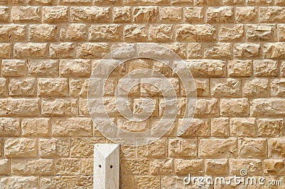 Texture of the wall built of rough yellow stone blocks Stock Photo