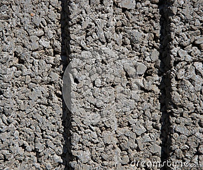 Texture of a wall of small, small gray stones with two dimples in the middle Stock Photo