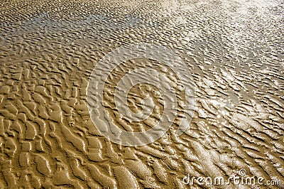 Texture of wet sea sand with patterns of water. Stock Photo