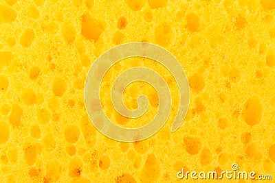 Texture yellow foam rubber, synthetic sponge with large pores, close-up background Stock Photo