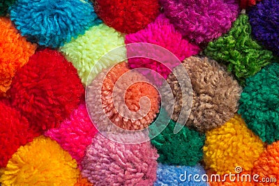 Textured background of assorted and multicolored wool pom poms Stock Photo