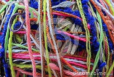 textured background of a tangle of multicolored yarn threads of different colors and thicknesses Stock Photo