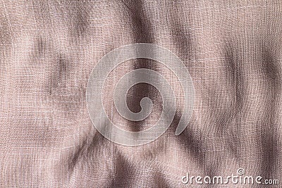 Textured beige fabric with visible weave patterns. The material appears soft and has gentle Stock Photo
