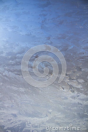 Textured frost patterns on the glass. A cold frosty day in winter. Stock Photo