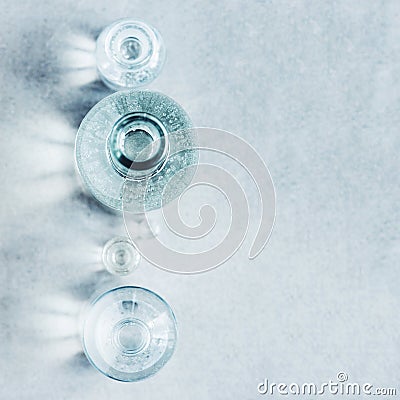 Textured gray background with various glass bottles and glare of Stock Photo