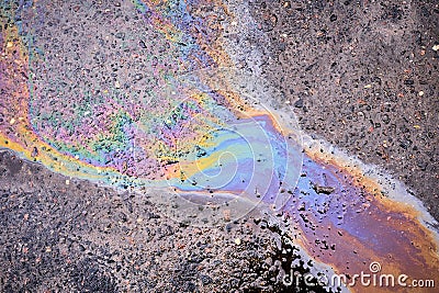 Textured stain of fuel or oil on wet asphalt on a rainy day Stock Photo