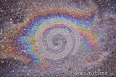 Textured stain of fuel or oil on wet asphalt on a rainy day Stock Photo