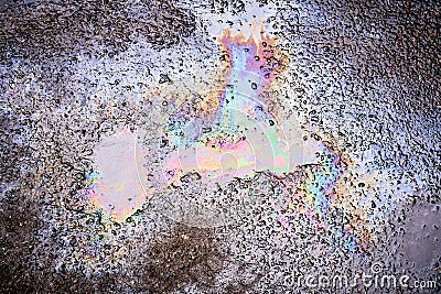 Textured stain of fuel or oil on wet asphalt on a rainy day. The concept of environmental pollution Stock Photo