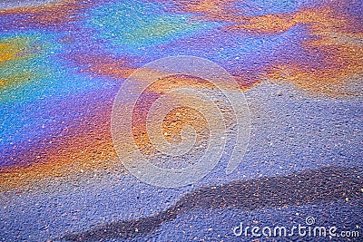 Textured stain of fuel or oil on wet asphalt on a rainy day Stock Photo