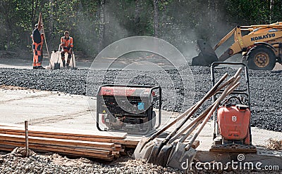 30th of August, Russia, Tomsk, road workers repair roadbed Editorial Stock Photo