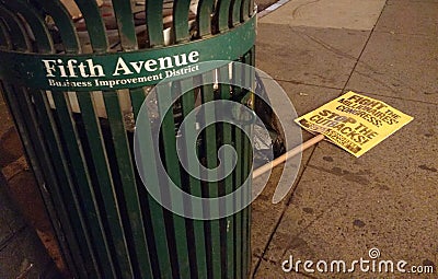 5th Avenue Business Improvement District, Political Protest Sign Near The Garbage, NYC, NY, USA Editorial Stock Photo