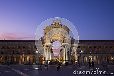 Arco da Rua Augusta and people at Praca do Comercio in Lisbon at dusk Editorial Stock Photo