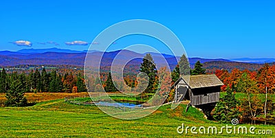 19th Century covered bridge in rolling green mountains of Vermont HDR. Stock Photo