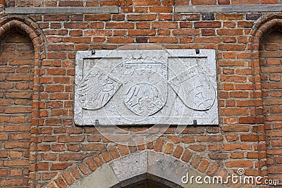 15th century Mariacka Gate by the river Motlawa, arm on the facade, Gdansk, Poland Stock Photo