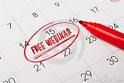 15th day of month marked with red circle. The phrase Free Webinar written in red text on a calendar page as a reminder. Closeup of Stock Photo